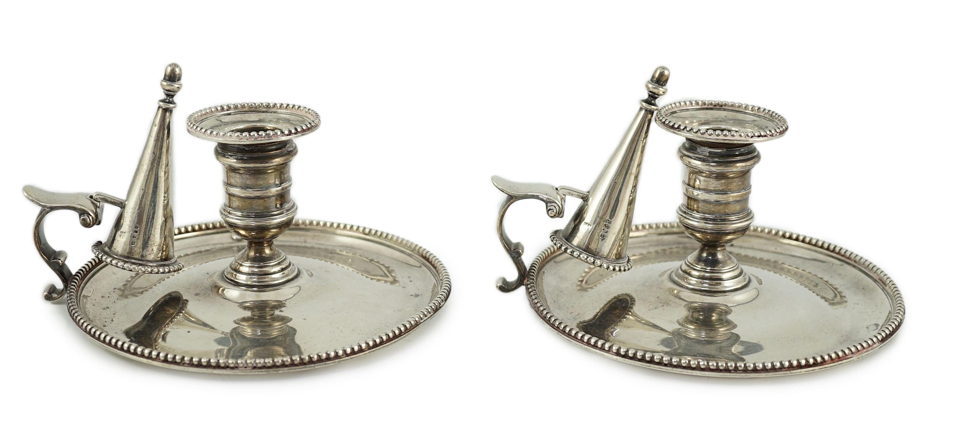 A pair of Victorian silver chambersticks and extinguishers, by Charles Thomas Fox and George Fox